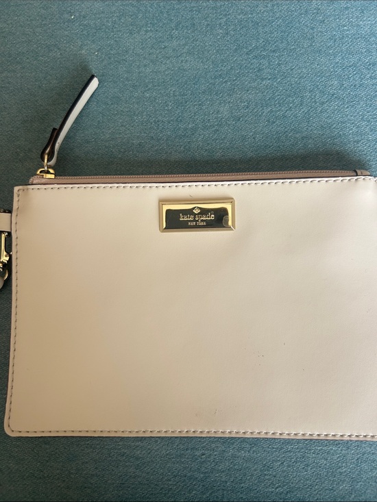 kate spade Handbags - kate spade cream leather wristlet with gold plaque